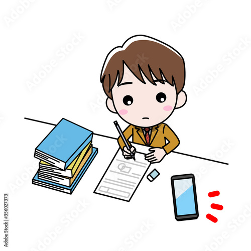 机に向かって勉強している男の子がスマホを気にしている