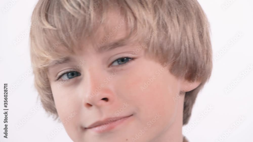 Close up portrait of a very beautiful cute blond boy, looking at the camera. Close up portrait of a very beautiful cute blond boy, looking at the camera.
