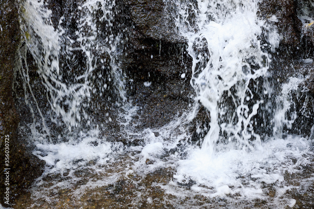 Close up of waterfall. Dynamic water flow. Waterscape background. Nature and environment concept. Pucak Manik waterfall Bali, Indonesia Close up of waterfall. Dynamic water flow. Waterscape background. Nature and environment concept. Pucak Manik waterfall Bali, Indonesia