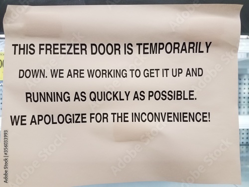 this freezer door is temporarily down sign