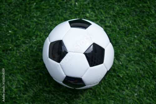Traditional soccer ball or football on soccer football field. Copy space for text 
