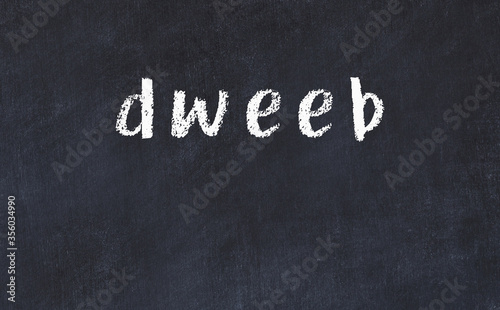 College chalk desk with the word dweeb written on in photo