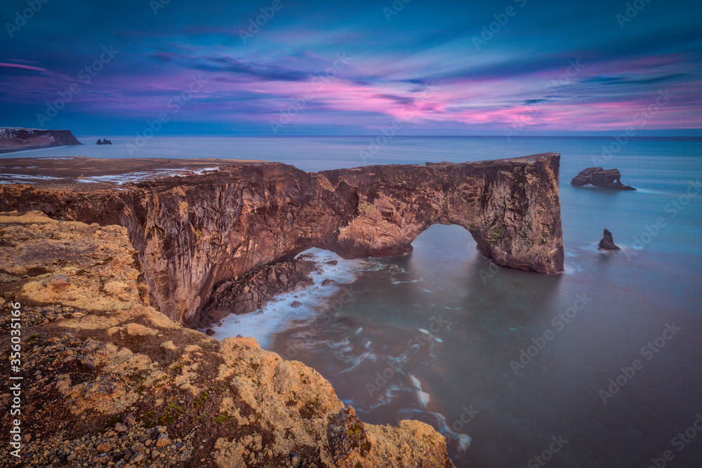 Sea cliffs of Dyrhólaey at sunset Sea cliffs of Dyrhólaey at sunset