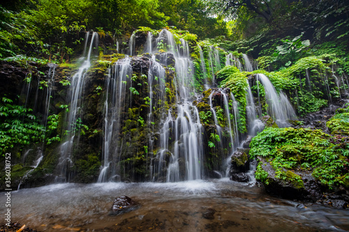 Waterfall landscape. Beautiful hidden waterfall in tropical rainforest. Nature background. Slow shutter speed, motion photography. Banyu Wana Amertha waterfall, Bali, Indonesia