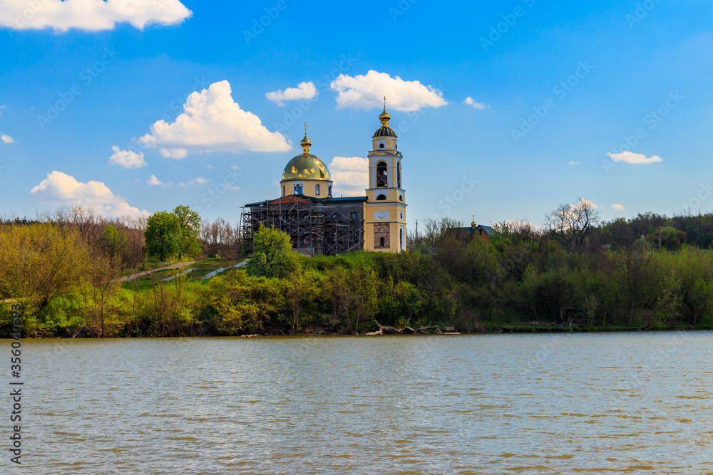 View of the beautiful lake and old orthodox church on a shore