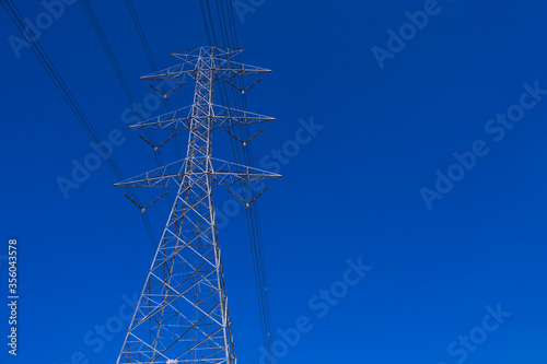 Electrical tower station wiring power with clearly blue sky background, High voltage station post