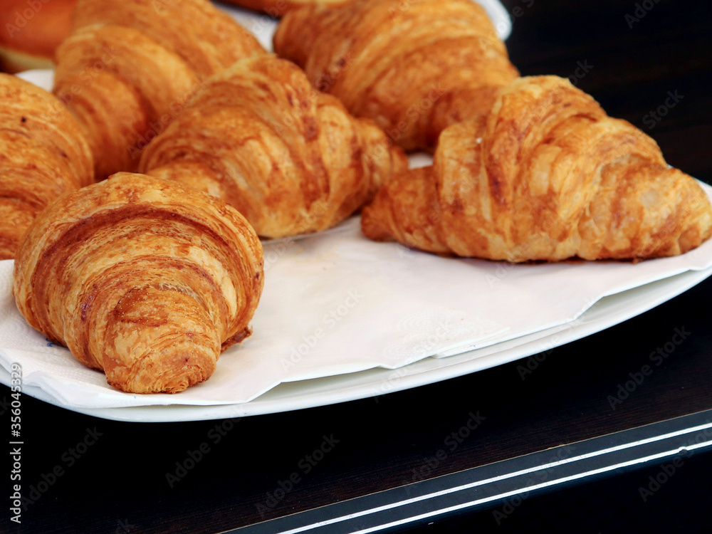 French breakfast. Croissants lying on a white plate. For culinary design