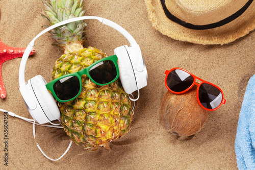 Pineapple and coconut with sunglasses and headphones