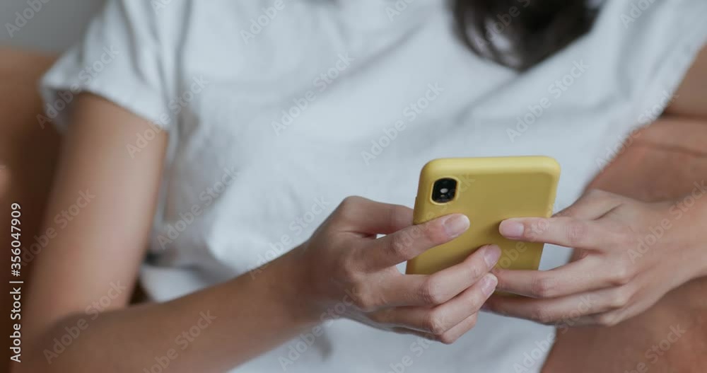 Close up of woman use of mobile phone at home Close up of woman use of mobile phone at home