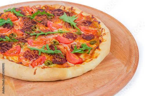 Pizza with thick outer ring on serving board located left