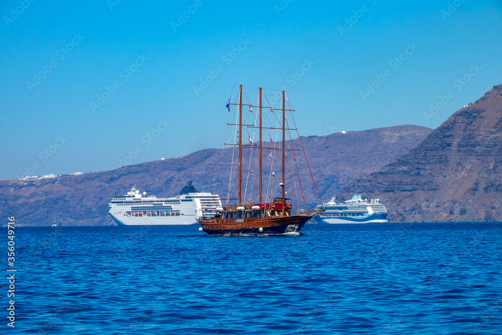 Modern Cruise Ships and Old Sailing Ship off the Coast of Santorini Modern Cruise Ships and Old Sailing Ship off the Coast of Santorini