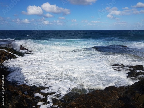 rocky shore at beach with waves in Isabela, Puerto Rico