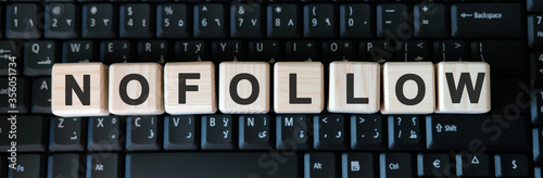 Nofollow web link - business concept text on wooden cubes on background black keyboard photo