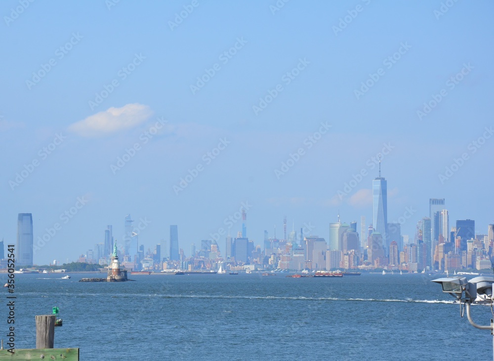 river water and statue of liberty and buildings in New York
