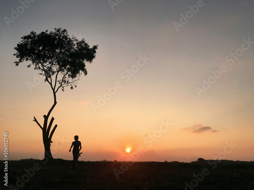 silhouette of a girl running on a sunset