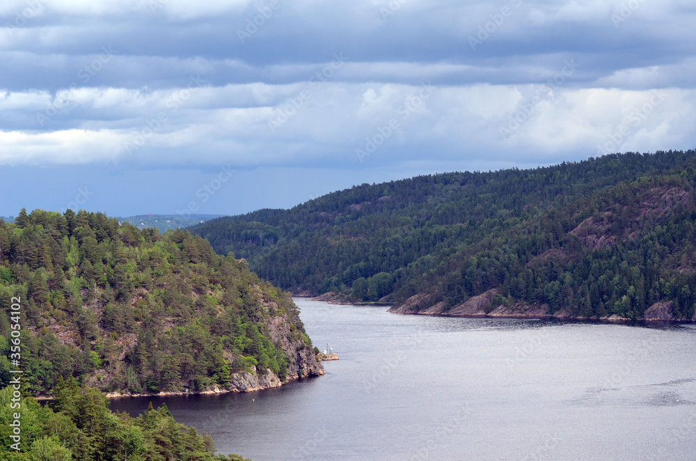 Typical Swedish nature and houses on the shore of the fjord. View from the high bridge over the fjord. The border of Norway and Sweden.Near the town Selater,Sweden Typical Swedish nature and houses on the shore of the fjord. View from the high bridge over the fjord. The border of Norway and Sweden.Near the town Selater,Sweden