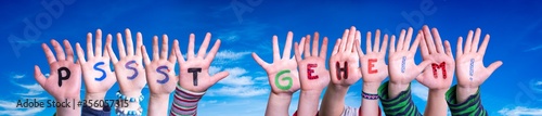 Children Hands Building Colorful German Word Pssst Geheim Means Pssst Secret. Blue Sky As Background