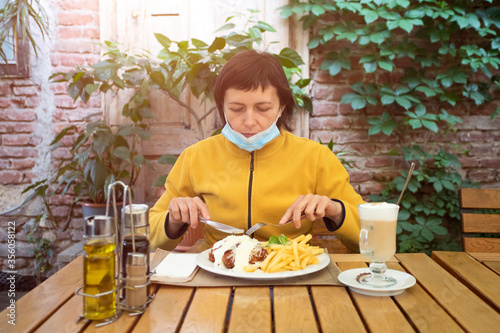 Woman in restaurant during coronavirus pandemic.