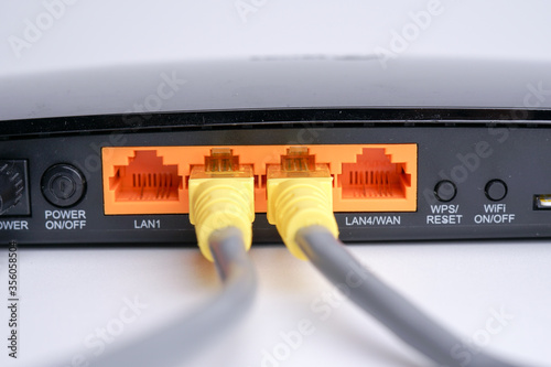 WiFi Modem Router ADSL connected with LAN RJ45 Cable. It is a LAN network connection ethernet cable. Internet cord RJ45 