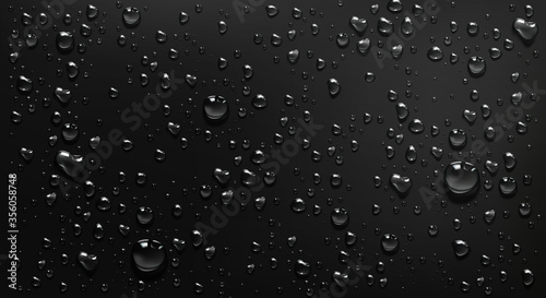 Condensation water drops on black glass background. Rain droplets with light reflection on dark window surface, abstract wet texture, scattered pure aqua blobs pattern Realistic 3d vector illustration photo