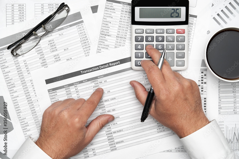 Top view of businessman working with financial statements. Modern black office desk with notebook, pencil and a lot of things. Flat lay table layout. Top view of businessman working with financial statements. Modern black office desk with notebook, pencil and a lot of things. Flat lay table layout.