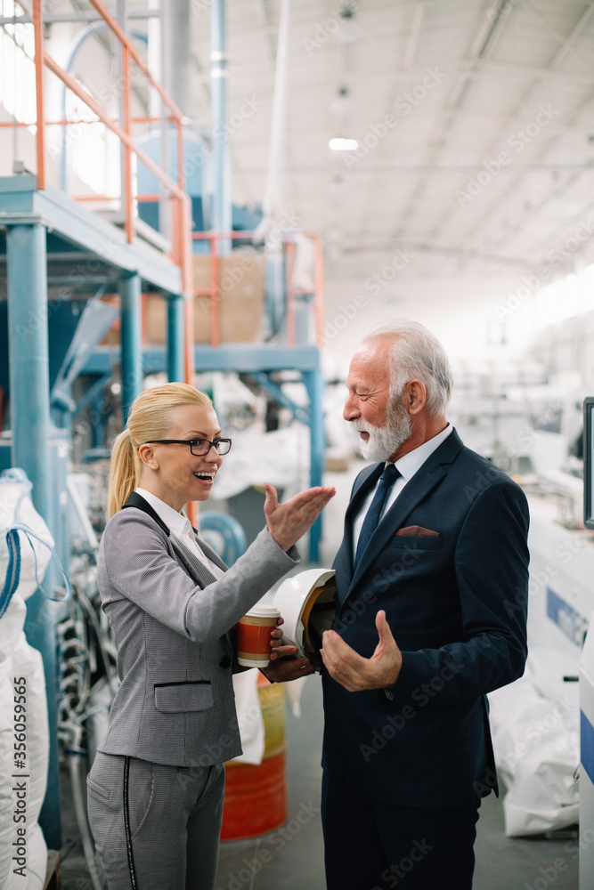 Man and woman discussing work. Colleagues working in factory.
Man and woman discussing work. Colleagues working in factory.