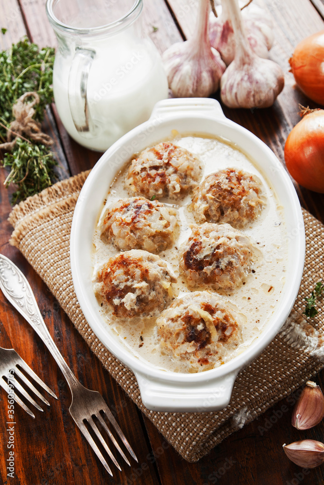 Meatballs with rice in a creamy sauce