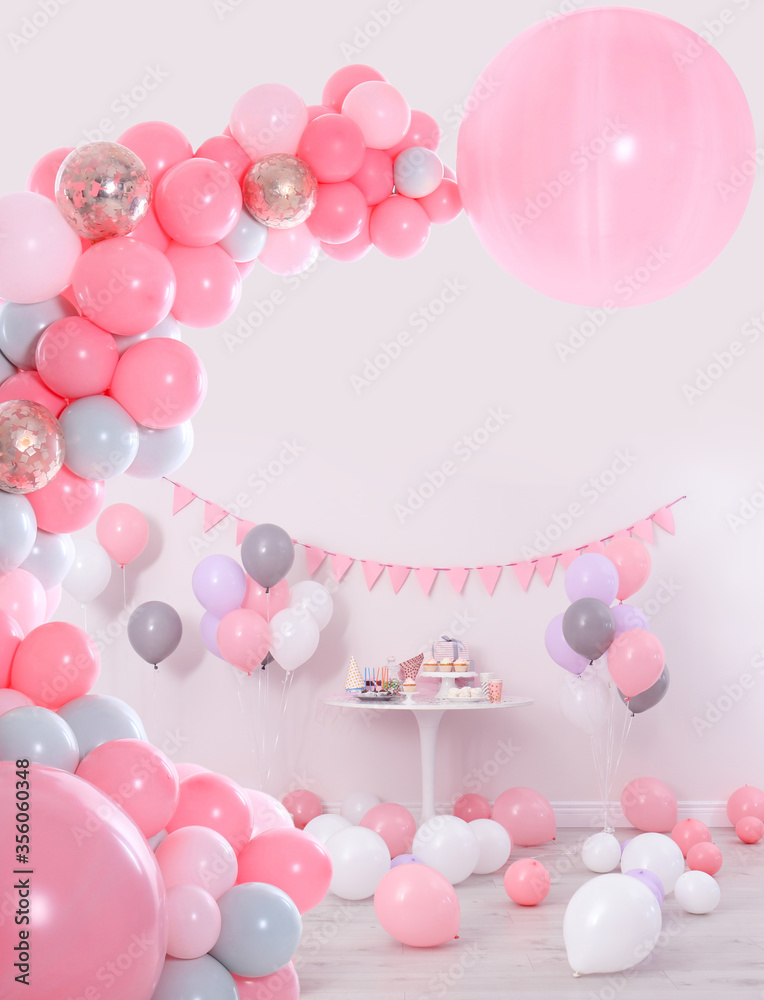 Baby shower party for girl. Different treats in room decorated with balloons Baby shower party for girl. Different treats in room decorated with balloons
