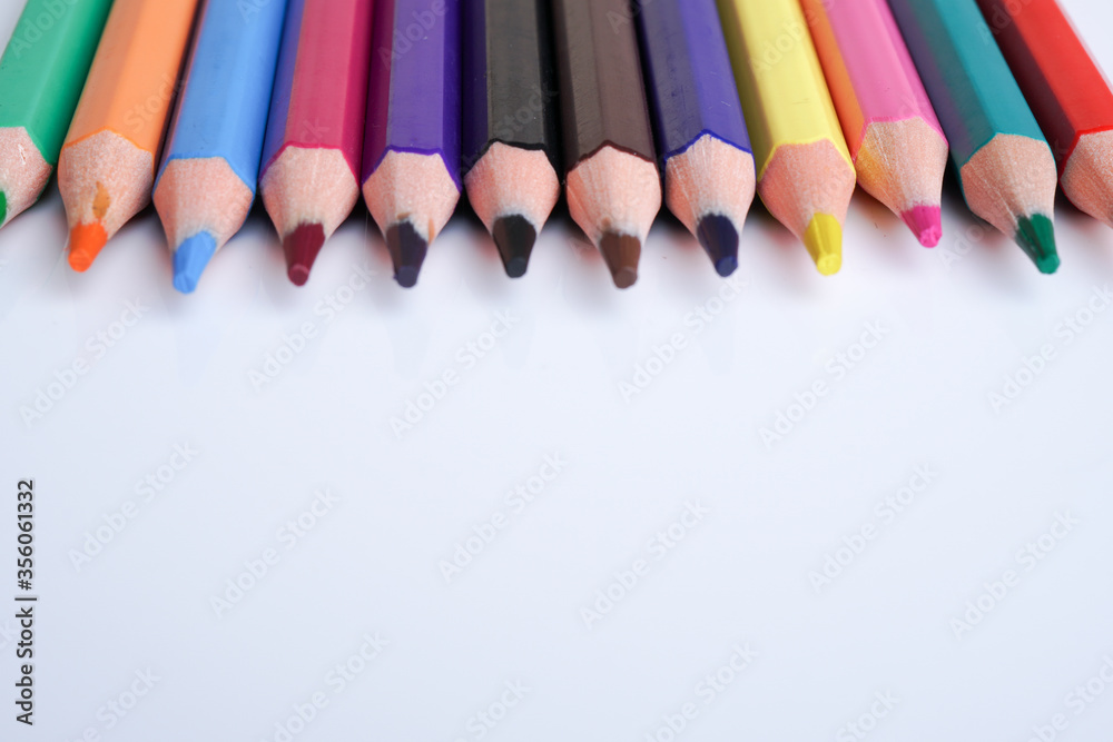 Close up color pencils isolated on white background space for text.
Close up color pencils isolated on white background space for text.