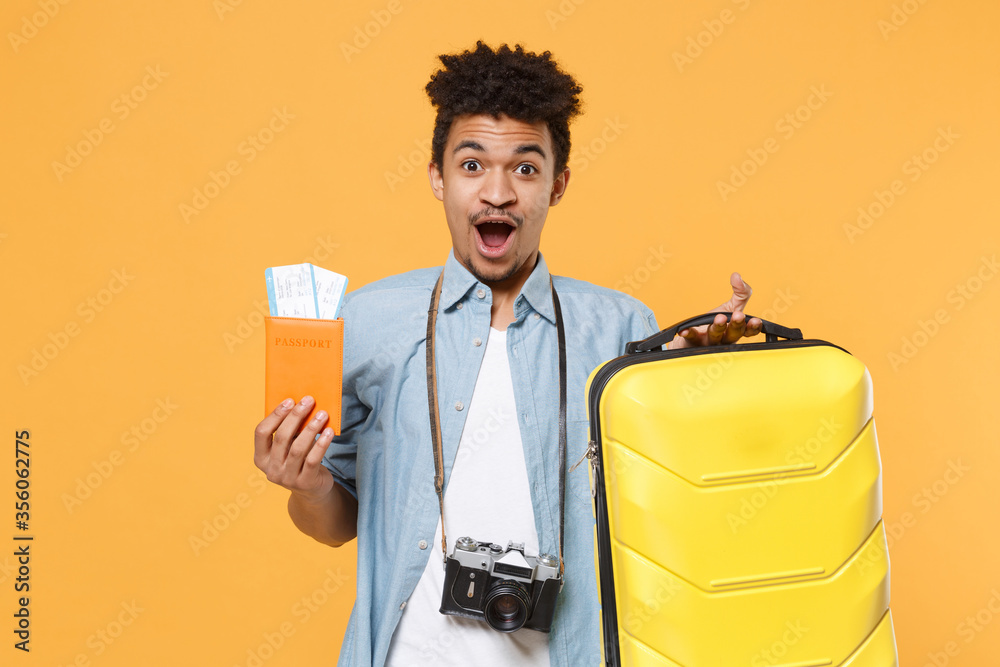 shocked-young-african-american-guy-in-blue-shirt-with-photo-camera-on