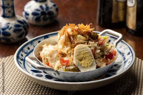 cod fish bacalhau with rice, onions eggs olive oil - portuguese traditional food