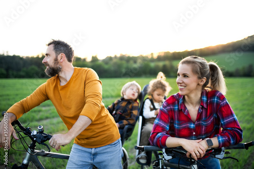 Family with two small children on cycling trip, having fun.