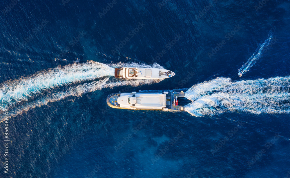 Aerial view of floating ship on blue Adriatic sea at sunny day. Fast ship on the sea surface. Seascape from the drone. Travel - image - obrazy, fototapety, plakaty 