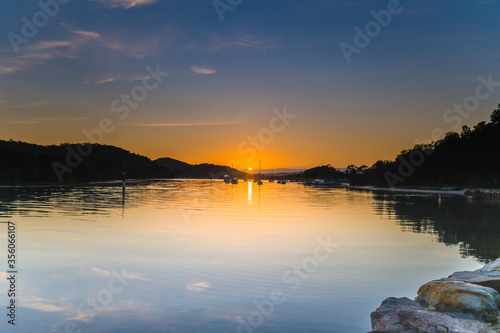 Soft and Light High Cloud Sunrise with Reflections over the Bay