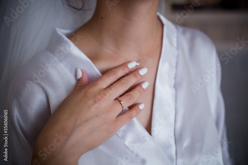 hand of the bride on the neckline