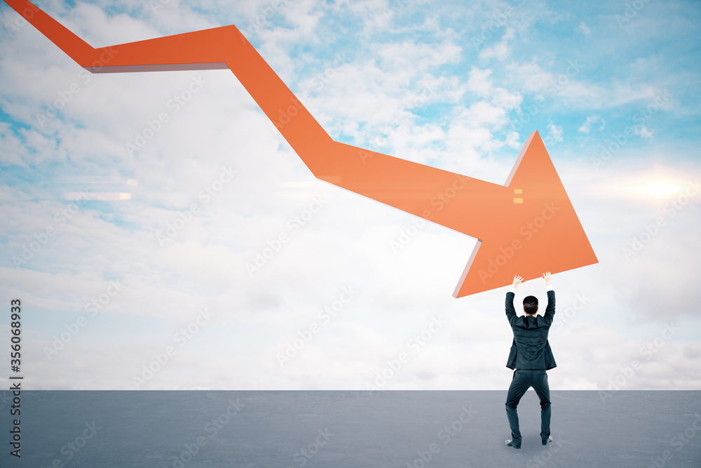 Obraz premium Businessman holding stock crash red arrow on cloud background.