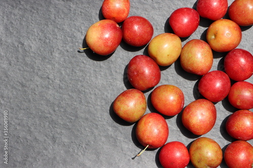 Fresh plum fruits on black background