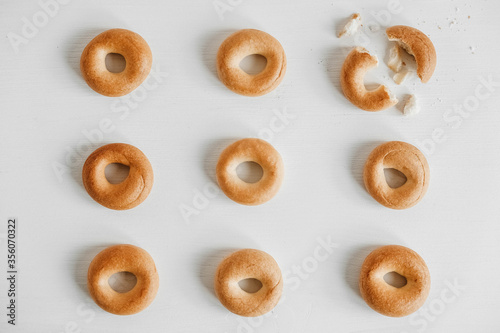Drying or mini round bagels on a white wooden background. Top view. Copy, empty space for text