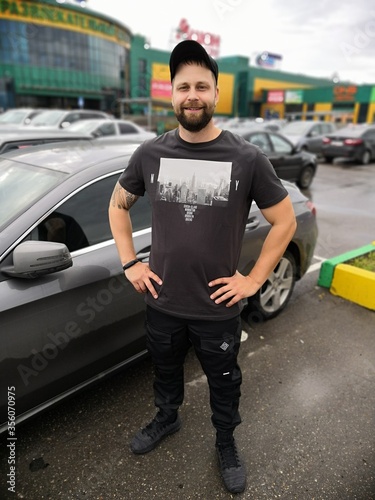 a man stands in the Parking lot of a shopping center © kapralov