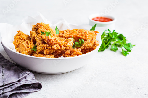 Crispy fried chicken in a white bowl.