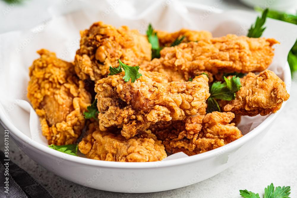 Crispy fried chicken in a white bowl. Crispy fried chicken in a white bowl.