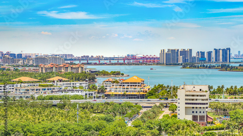 Haikou Cityscape in the Bay Area with Residential Buildings and Container Sea Port, The Capital City of Hainan Free Trade Zone, China, Asia.
