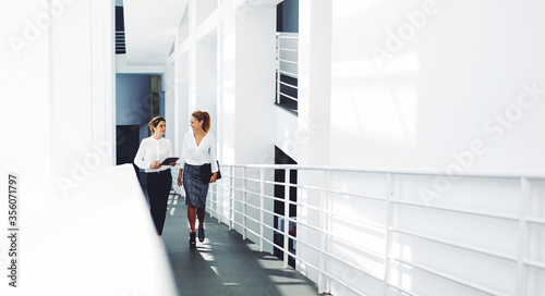 , confident women entrepreneurs working on touch pad while going to the conference room