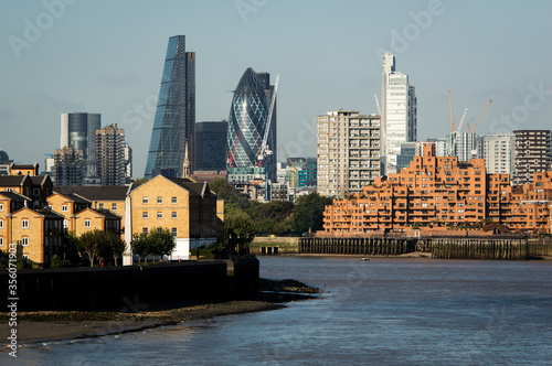 Cityscape of London over Thames River. Sunny day with blue sky.