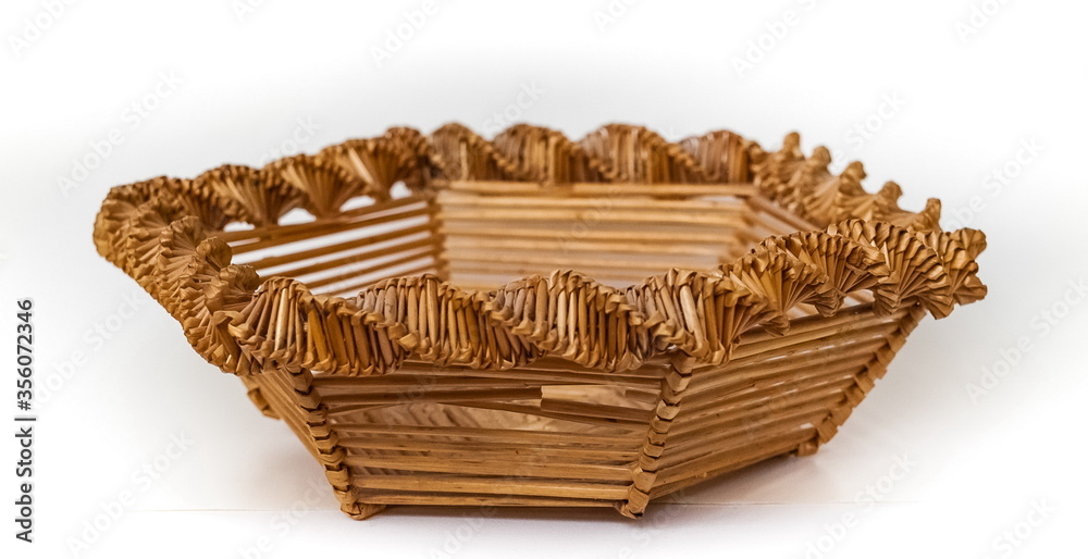 Obraz premium Purchased wicker straw vase close up isolated on white background