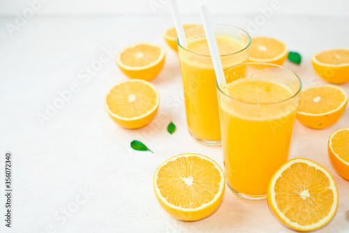 fresh orange Juice and oranges on the cutting board