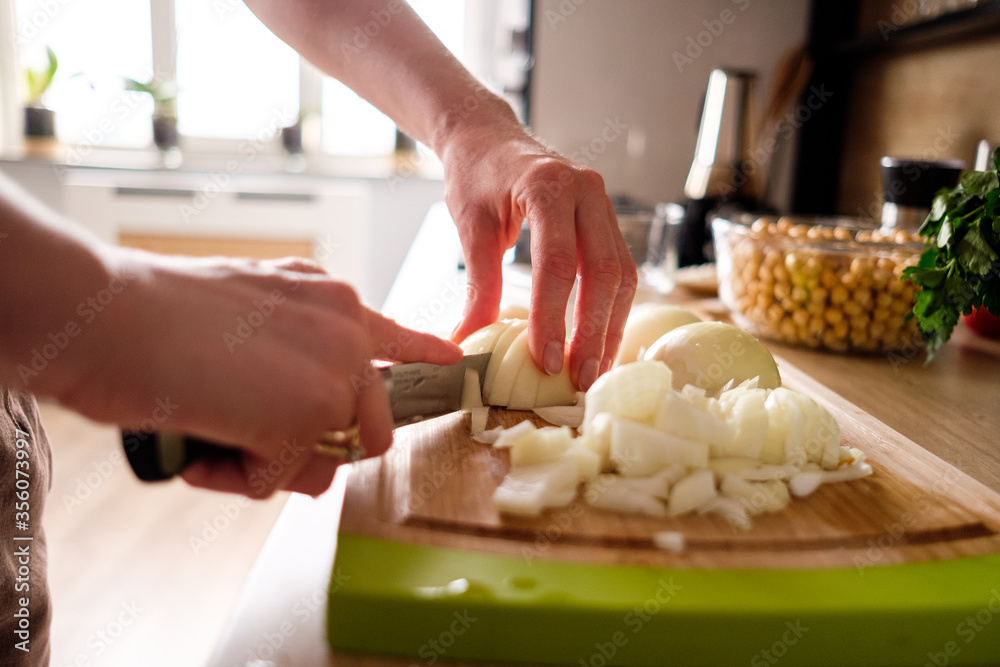 Woman hands, cutting onions, dill while preparing ingredients for falafel. Healthy diet Woman hands, cutting onions, dill while preparing ingredients for falafel. Healthy diet