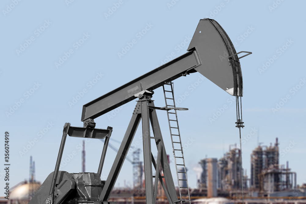 Silhouette of an oil rig, against the background of a chemical plant, on a summer day, medium plan Silhouette of an oil rig, against the background of a chemical plant, on a summer day, medium plan