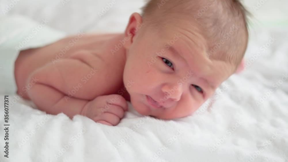 Cute little newborn baby girl sleeping in a dream Cute little newborn baby girl sleeping in a dream
