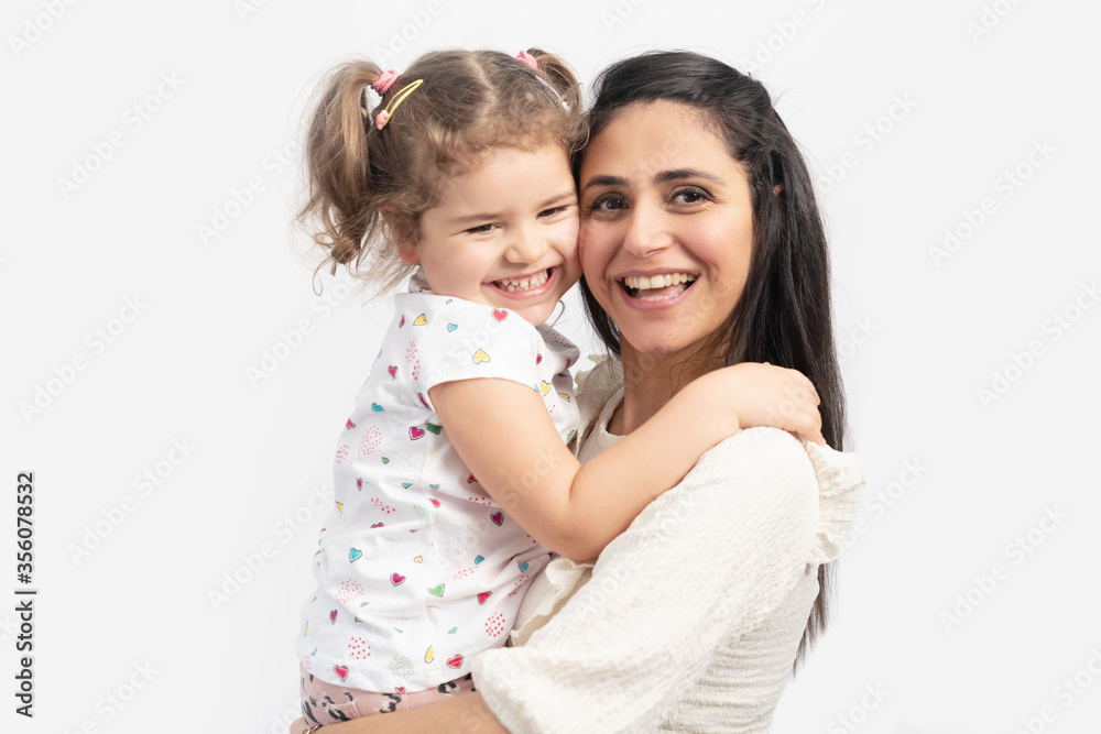 Portrait of happy loving mother and her baby hugging eachother with a smiley face. Portrait of happy loving mother and her baby hugging eachother with a smiley face.